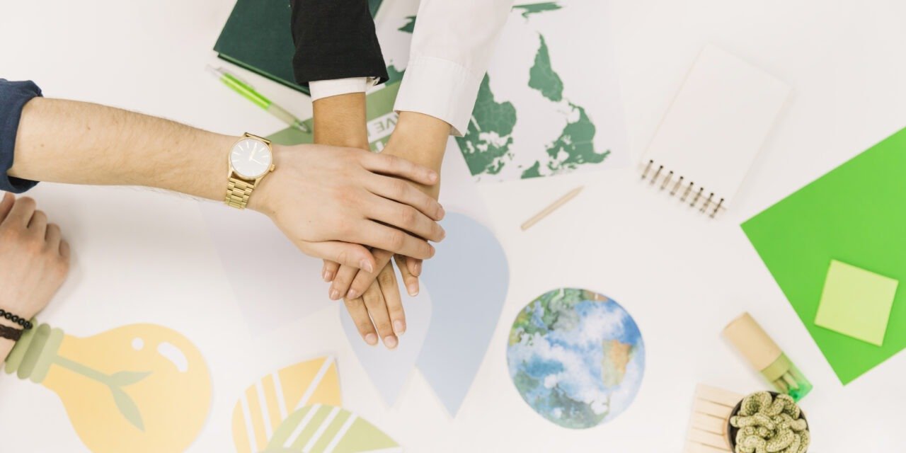 group-of-businesspeople-stacking-their-hands-over-desk-1280×640